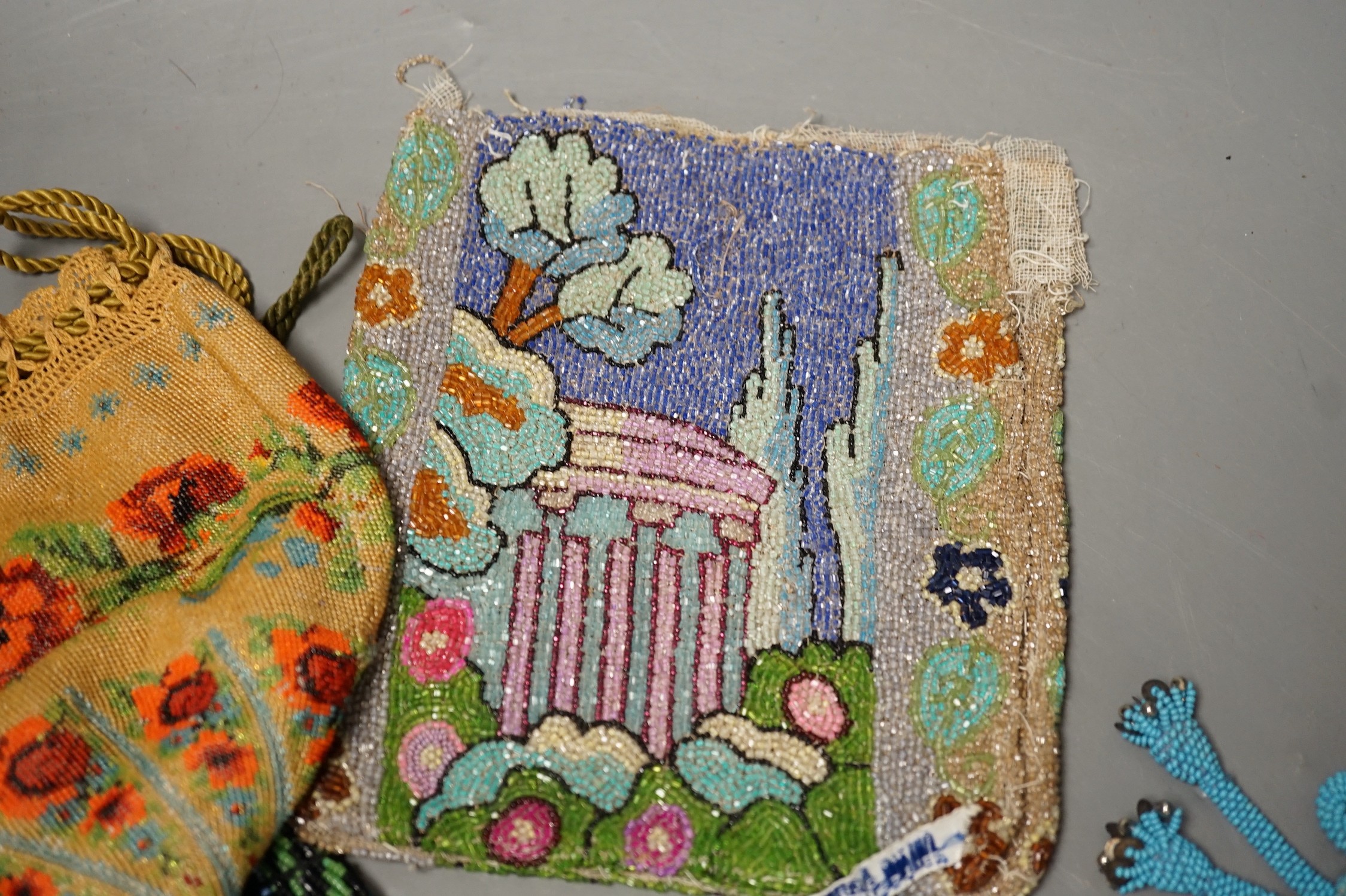 A late 19th century floral bead worked drawstring bag, a later jazz age beaded bag, a turquoise plain bead bag with zip and an unlined bead bag with a classical scene, (4)